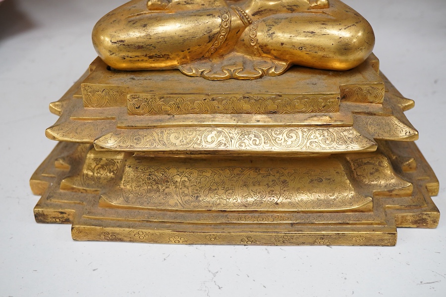 A gilt bronze figure of Manjushri, 31cm